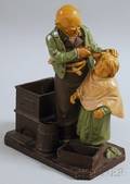 European Painted Ceramic Barber and Boy Figural Group Tobacco Stand