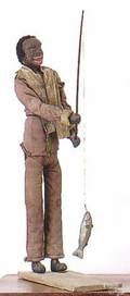 Carved and polychrome painted figure of a black man fishing early 20th c
