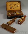 Two Boxed Sets of Dominoes a Brass and Wood Cribbage Board and an Eightpiece Travel Liquor Set in a Leather Case