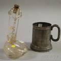 Colorless Molded Glass Phallic Figural Bottle and a Pewter Tankard with Erotic Stained Glass Bottom