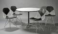 Four Charles and Ray Eames Chairs and a Table