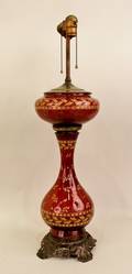A Victorian Cranberry Enameled Lamp