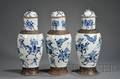 Three Blue and White Tall Jars and Covers