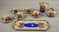 Thirteenpiece Austrian Gilt and Genre Scenedecorated Porcelain Partial Tea Service