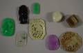 Nine Assorted Asian Carved Jade and Jadeite Pendants
