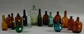 Sixteen Assorted Colored Mostly Molded Glass Bottles