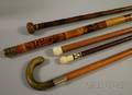 Four Wooden and Bamboo Walking Sticks and a Hornhandled Cane