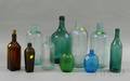 Ten Assorted Colored Molded Glass Bottles and Flasks
