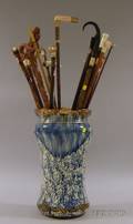 Nineteen Canes and Walking Sticks in a Gilt and Sponge Decorated Art Pottery Stand