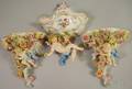 Pair of Handpainted German Porcelain Cherub Figural Wall Brackets and a Wall Pocket