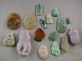 Approximately Fifteen Asian Carved Jade and Stone Pendants