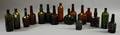 Fifteen Amber and Olive Molded Glass Liquor Bottles