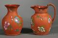 Two Wedgwood Enamel Decorated Rosso Antico Items
