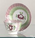 Red and green rainbow spatter cup and saucer