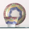 Vibrant red green yellow and blue rainbow drape cup and saucer