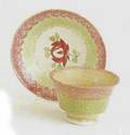 Red and green rainbow spatter cup and saucer