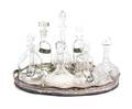 A Collection of Nine Glass Decanters and Silverplate Tray