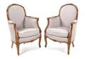 A Pair of Louis XV Style Walnut Bergeres