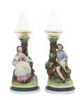 A Pair of Continental Bisque Porcelain Figural Candlesticks