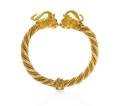 An 18 Karat Yellow Gold and Ruby Rams Head Bangle Bracelet