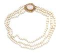 A 14 Karat Yellow Gold Shell Cameo and Graduated White Coral Multistrand Bead Necklace