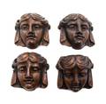 A Set of Four Carved Oak Masks