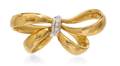 An 18 Karat Two Tone Gold and Diamond Bow Brooch