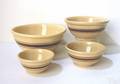 Four graduated yellow ware bowls