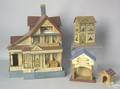 Four doll houses to include a carved and painted house