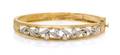A 14 Karat Yellow Gold and Diamond Bangle Bracelet