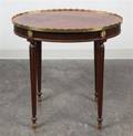 A Louis XVI Style Gilt Metal Mounted Mahogany Side Table