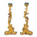 A Pair of Italian Rococo Carved and Parcel Gilt Candlesticks