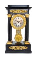An Empire Gilt Metal Mounted Ebonized Portico Clock