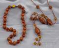 Two Carved Peach Pit and Amber Bead Necklaces