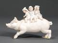 Tinted Bisque Figural Group of Children Riding a Wild Boar