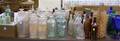 Approximately 156 Colorless Aqua and Colored Glass Bottles