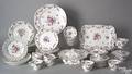 Partial porcelain dinner service with rose decoration