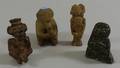 Three Ethnographic Pottery and Carved Stone Seated Figures and an Eskimo Carved Soapstone Figure