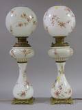 Pair of Late Victorian Brassmounted Transfer Floral Decorated Opaque Glass Kerosene Banquet Lamps with Globe Shades
