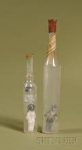 Two Miniature Novelty Bottles Containing Frozen Charlottes