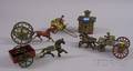 Four Painted Horse and Carriage Toys and a Cast Iron Still Bank
