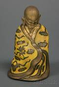 Enameled and Engraved Brass Figure of a Seated Buddhist Saint
