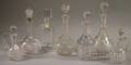Four Colorless Cut Glass Decanters Two Cruets and a Kosta Boda Crystal Decanter
