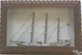Carved and painted half hull model in a shadowbox