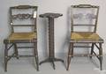 Pair of painted fancy chairs and a folk art candlestand