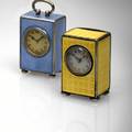 A PAIR OF SILVER AND ENAMEL MINIATURE CLOCKS A