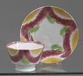 Vibrant yellow red and green rainbow spatter cup and saucer