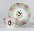 Red and green rainbow spatter cup and saucer