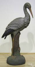 Continental polychrome decorated plaster figure of a stork standing on a tree stump
