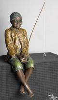Full bodied painted plaster sculpture of a seated black boy ca 1900